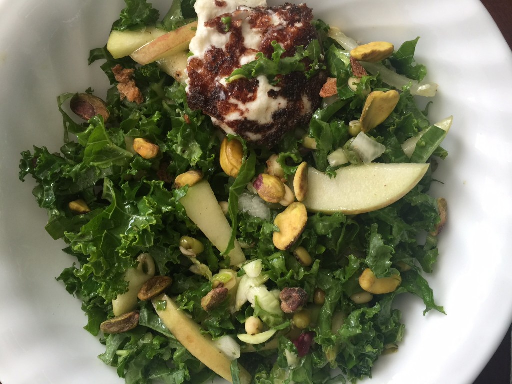 Kale salad with apple, brussels sprouts and pistachios.